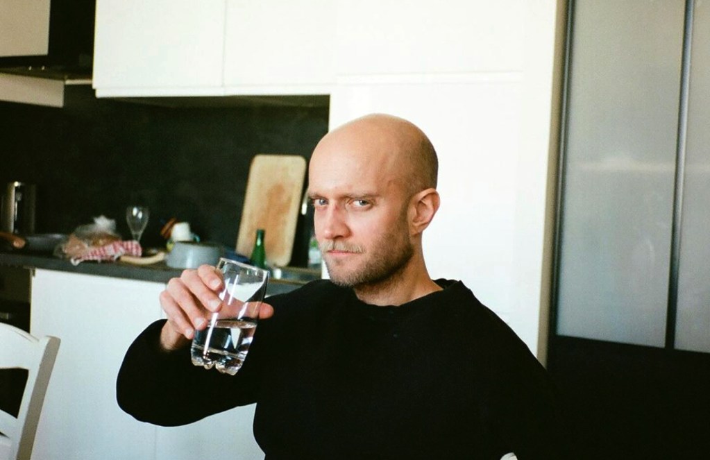 'Beyond Boards' podcast host Quentin Delille drinking a glass of water.
